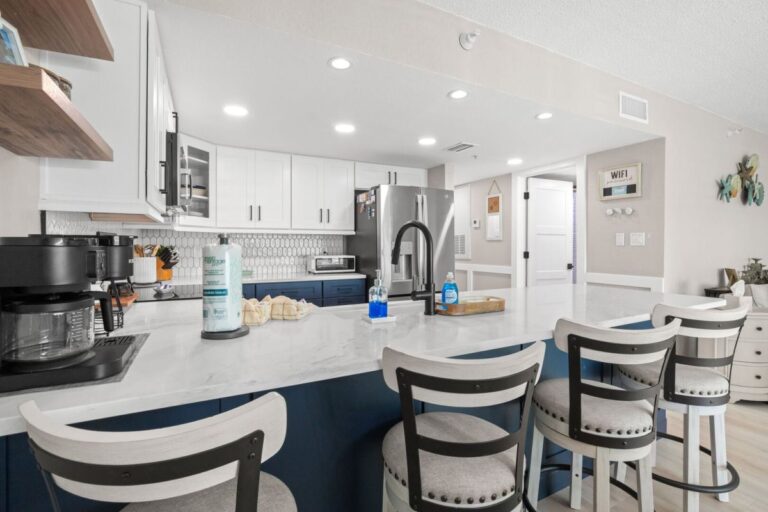 Kitchen bar with counter stools coffee station and stainless steel appliances in Indian Rocks Beach condo
